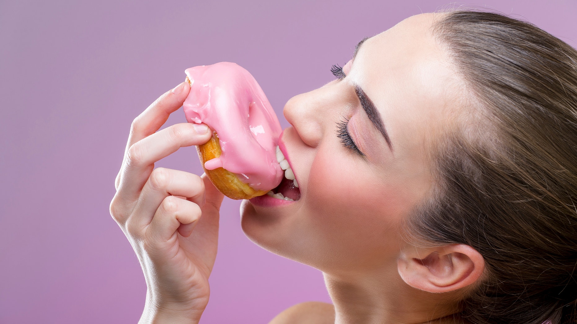 Beautiful sensual woman, eat a donut