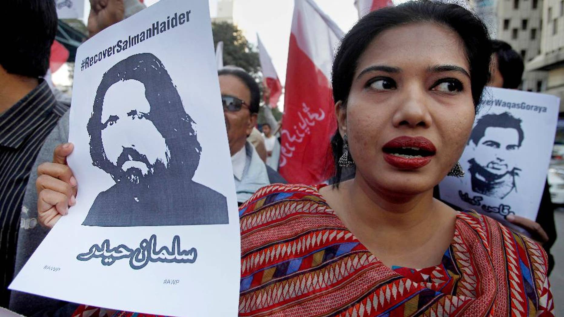 FILE - In this Tuesday, Jan. 10, 2017 file photo, a woman joins other demonstrators to condemn missing human rights activists, in Karachi, Pakistan. Pakistan banned Amir Liaqat, a TV host, over incitement and registered a criminal case against him Thursday, Jan. 26, 2017, after he called for five missing human rights activists and other liberal Pakistanis to be killed for blasphemy and sedition, officials said. The state media regulator said that Liaqat, a self-styled religious scholar, could no longer appear on the pro-military BOL TV, where he hosted a daily program, or any other local broadcast. (AP Photo/Fareed Khan, File)