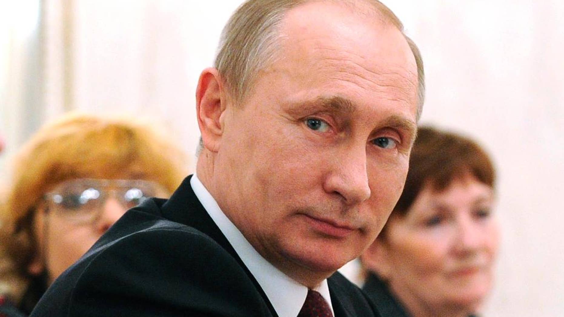 Russian President Vladimir Putin attends an International Women's Day celebration in the Kremlin, in Moscow, Russia, Sunday, March 8, 2015. (AP Photo/RIA-Novosti, Mikhail Klimentyev, Presidential Press Service)