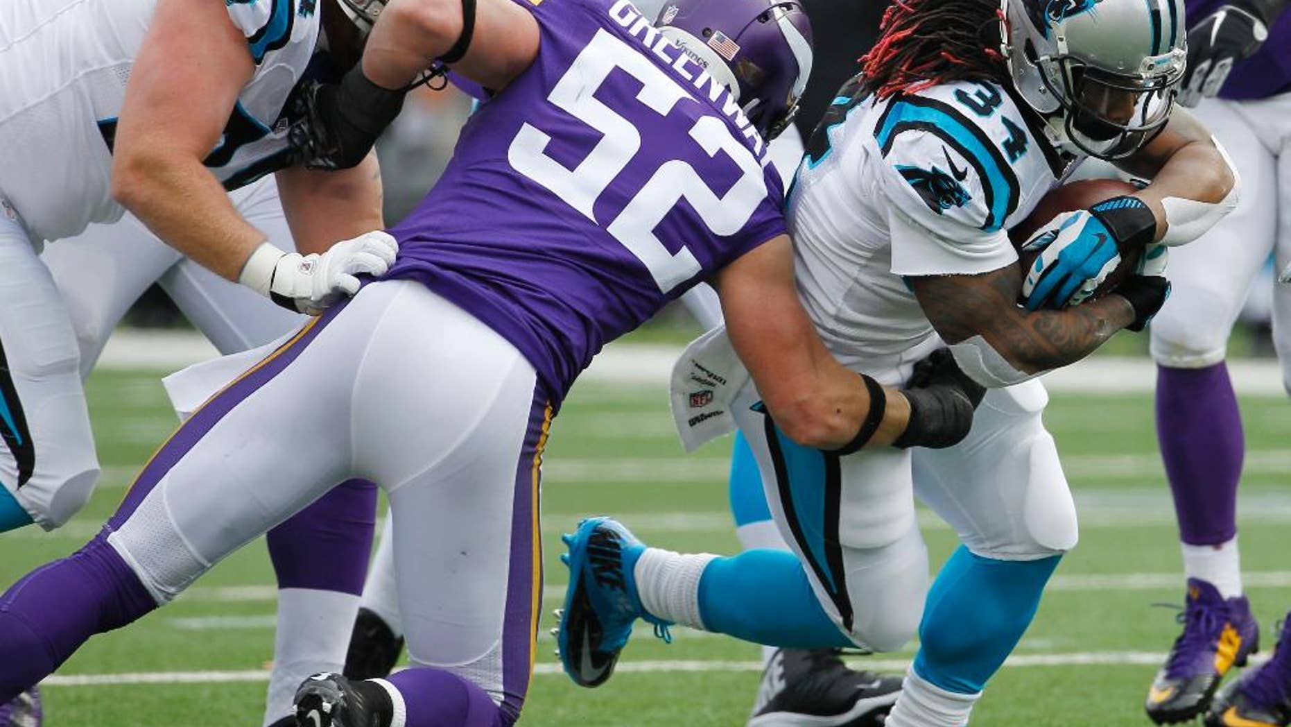Carolina Panthers running back DeAngelo Williams (34) tries to break a tackle by Minnesota Vikings outside linebacker Chad Greenway (52) during the first half of an NFL football game, Sunday, Nov. 30, 2014, in Minneapolis. (AP Photo/Ann Heisenfelt)