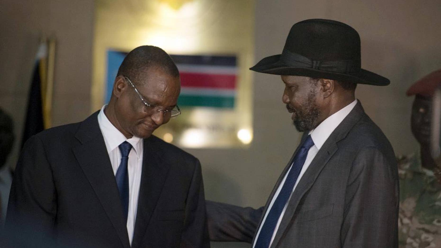 South Sudan's First Vice President Taban Deng Gai, left, speaks with President Salva Kiir, right.