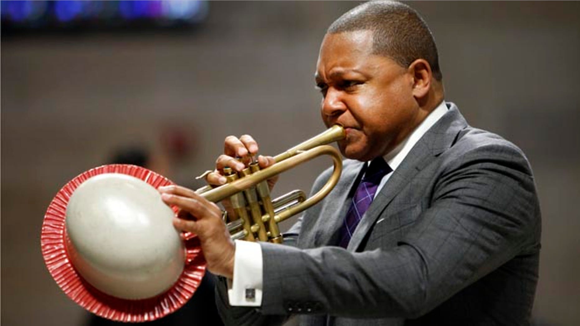 FILE - In this Sept. 20, 2014, file photo, musician Wynton Marsalis performs during a memorial service for actress Ruby Dee at The Riverside Church in New York. It was announced Wednesday, March 11, 2015, that Marsalis is scratching a concert in Venezuela amid rising tensions between Venezuela and the U.S. that are making it harder for U.S. citizens to travel to the South American country. (AP Photo/Jason DeCrow, File)