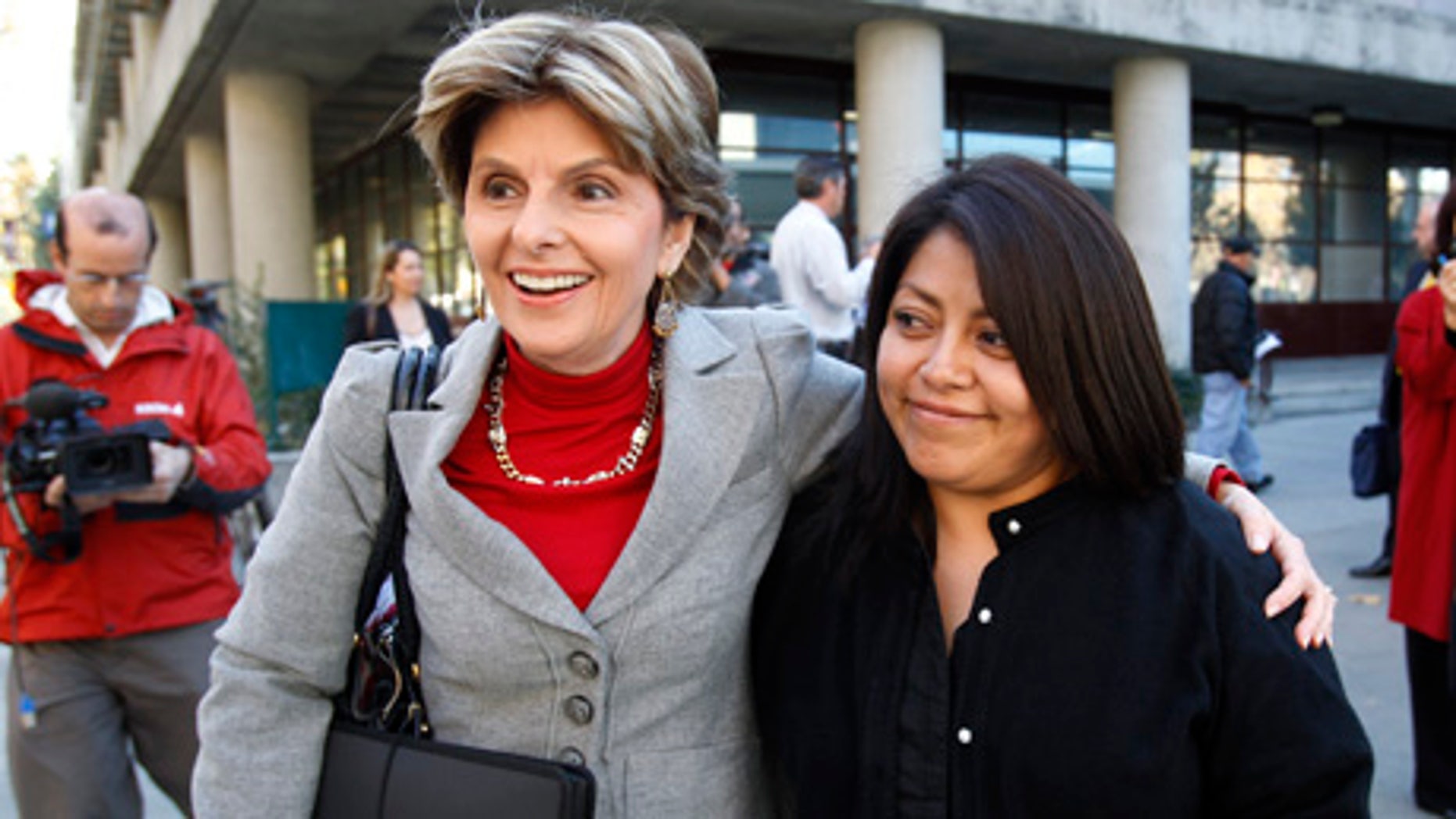 Nicky Diaz Santillan, right, and her attorney Gloria Allred, left, smile as they leave a hearing in San Jose, Calif., Wednesday, Nov. 17, 2010. Diaz Santillan, the illegal immigrant housekeeper who helped derail Meg Whitman's gubernatorial campaign, took her case before the California Department of Industrial Relations. She claims the former eBay CEO and billionaire owes her $6,210 in unpaid wages and mileage reimbursements accrued during the nine years she spent as the Whitman family's housekeeper. (AP Photo/Paul Sakuma)