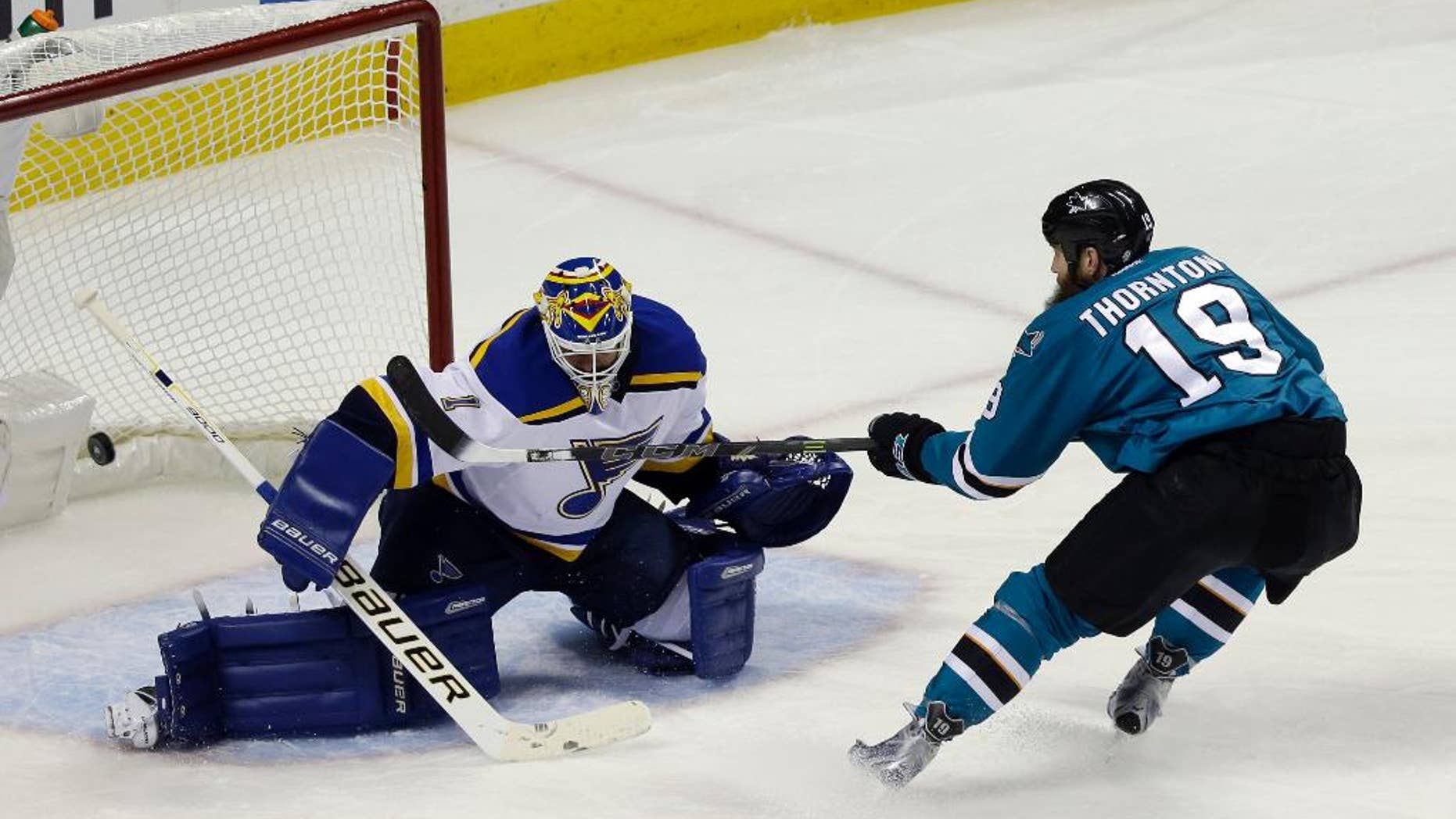 St. Louis Blues goalie Brian Elliott (1) deflects a shot from San Jose Sharks' Joe Thornton (19) during the first period in Game 6 of the NHL hockey Stanley Cup Western Conference finals Wednesday, May 25, 2016, in San Jose, Calif. (AP Photo/Jeff Chiu)