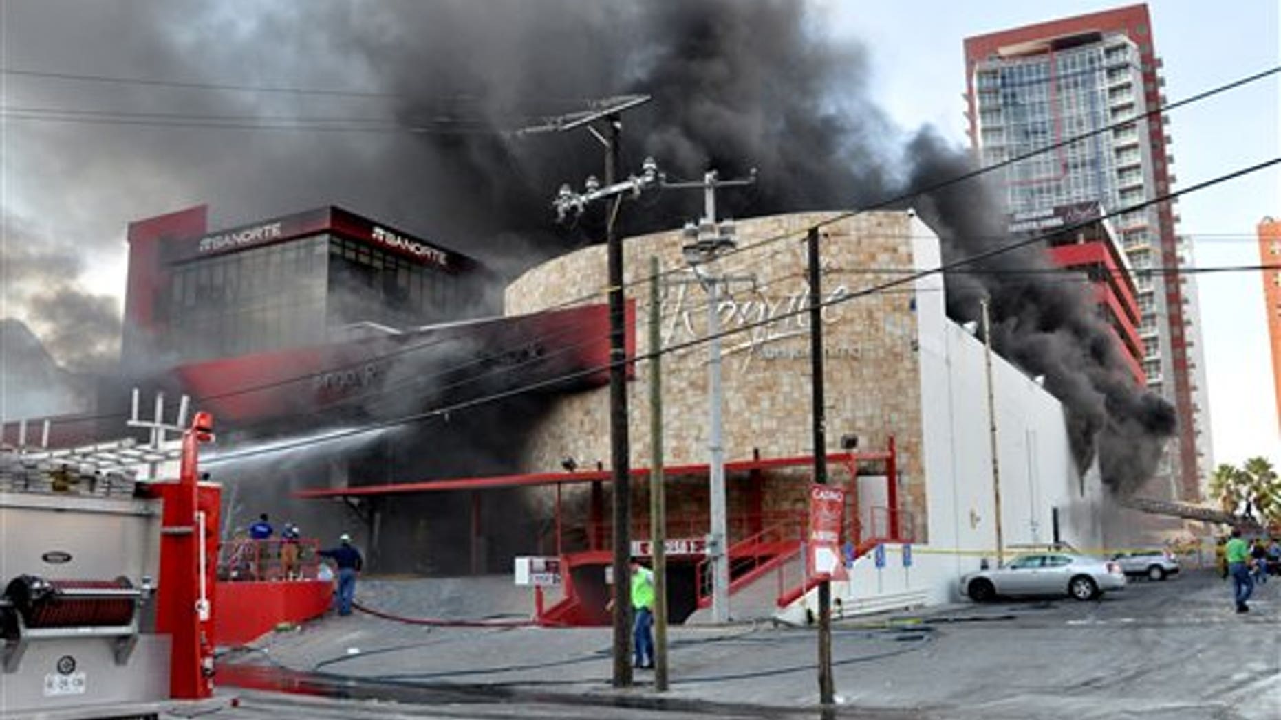 Smoke billows from the Casino Royale in Monterrey, Mexico, Thursday Aug. 25, 2011. Two dozen gunmen burst into the casino in northern Mexico on Thursday, doused it with a flammable liquid and started a fire that trapped gamblers inside, killing at least 32 people and injuring a dozen more, authorities said. (AP Photo)