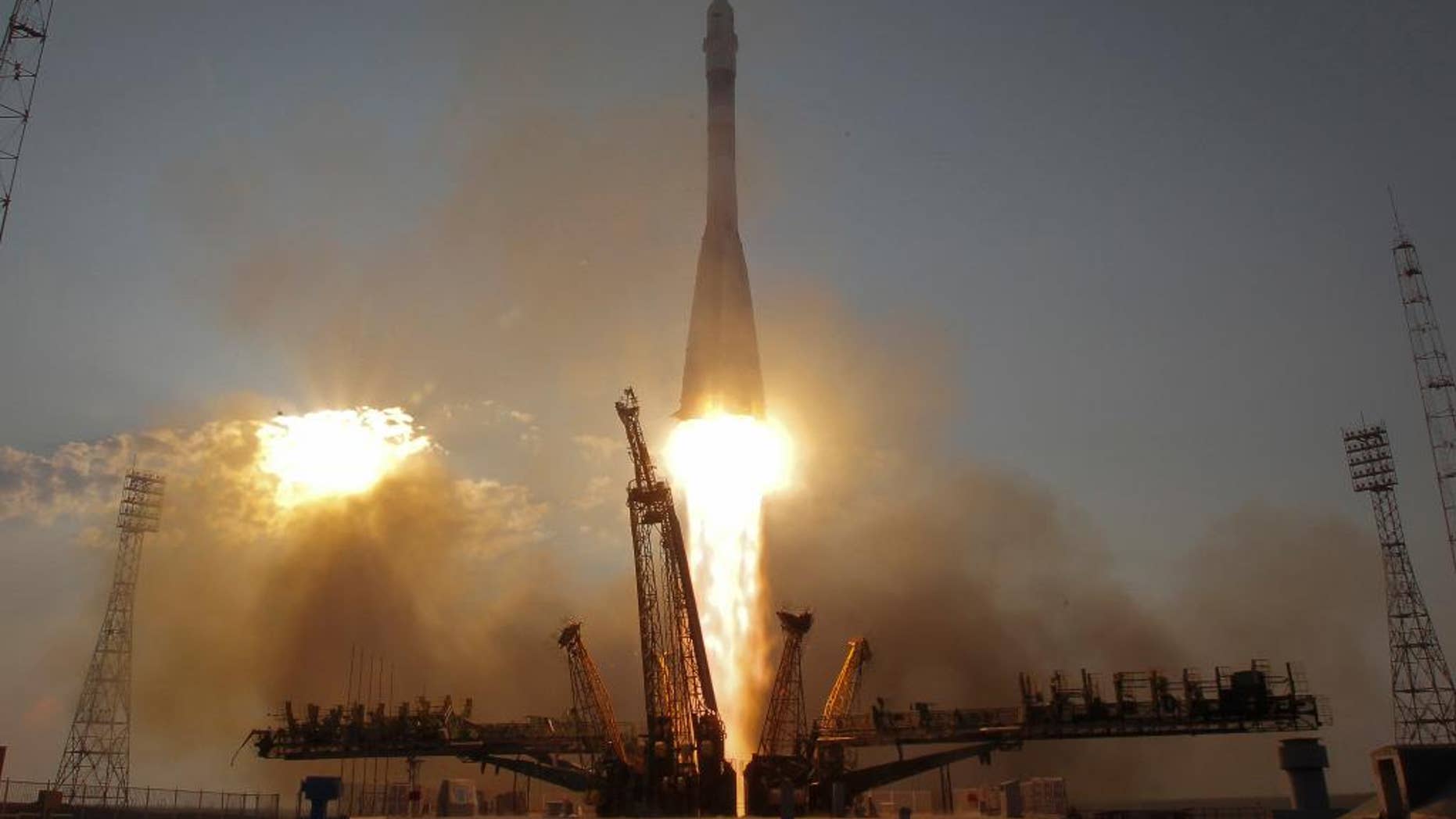 FILE - In this Thursday, July 7, 2016, file photo, the Soyuz-FG rocket booster with Soyuz MS space ship carrying a new crew to the International Space Station, ISS, blasts off at the Russian leased Baikonur cosmodrome, Kazakhstan. The capsule carrying astronauts from Russia, Japan and the United States has docked with the International Space Station Saturday after a two-day voyage. (AP Photo/Dmitri Lovetsky, File)