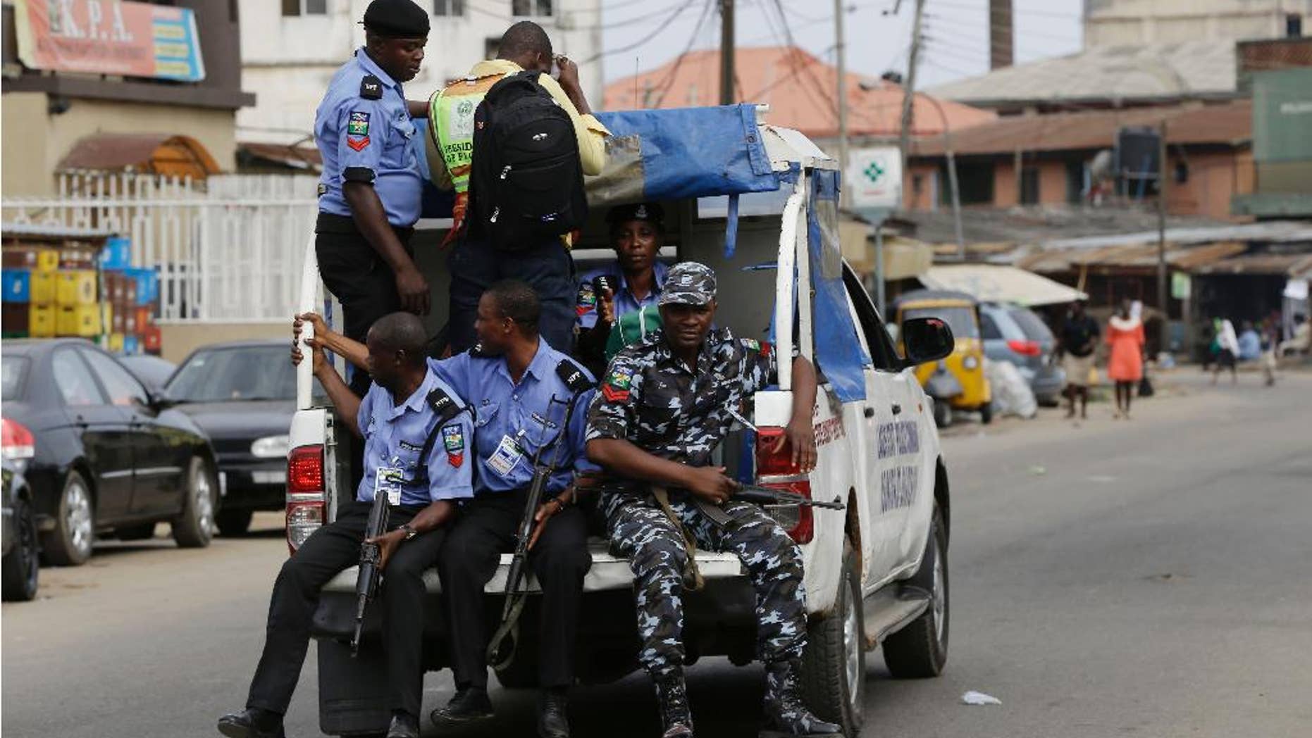 Nigeria Police transport election results at the end of voting in one of the polling station in Lagos, Nigeria, Saturday, April 11, 2015. Nigeria goes to the polls Saturday to elect governors and state Assembly.(AP Photo/Sunday Alamba)