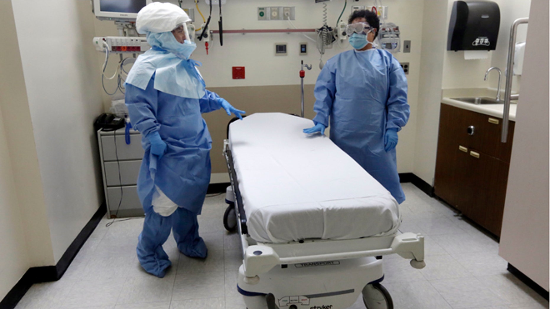 Oct. 8, 2014: Bellevue Hospital nurse Belkys Fortune, left, and Teressa Celia, Associate Director of Infection Prevention and Control, wear protective suits in an isolation room in the Emergency section of the hospital during a demonstration of procedures for possible Ebola patients in New York.