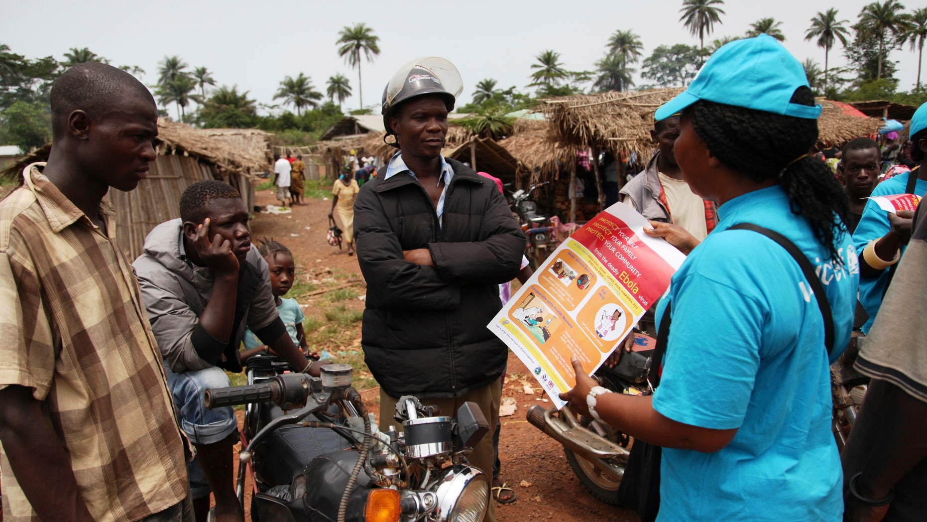 A UNICEF worker speaks with drivers of motorcycle taxis about the symptoms of Ebola virus disease (EVD) and best practices to help prevent its spread, in the city of Voinjama, in Lofa County, Liberia. REUTERS