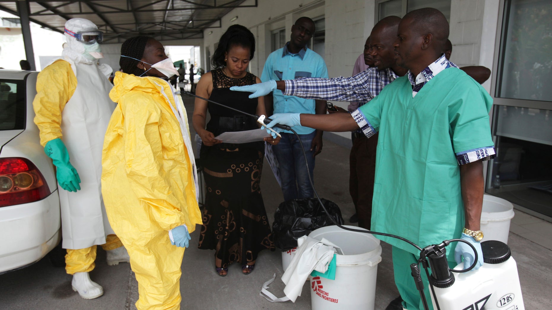 A health worker sprays a colleague with disinfectant during a training session for Congolese health workers to deal with Ebola virus in Kinshasa October 21, 2014. REUTERS/Media Coulibaly