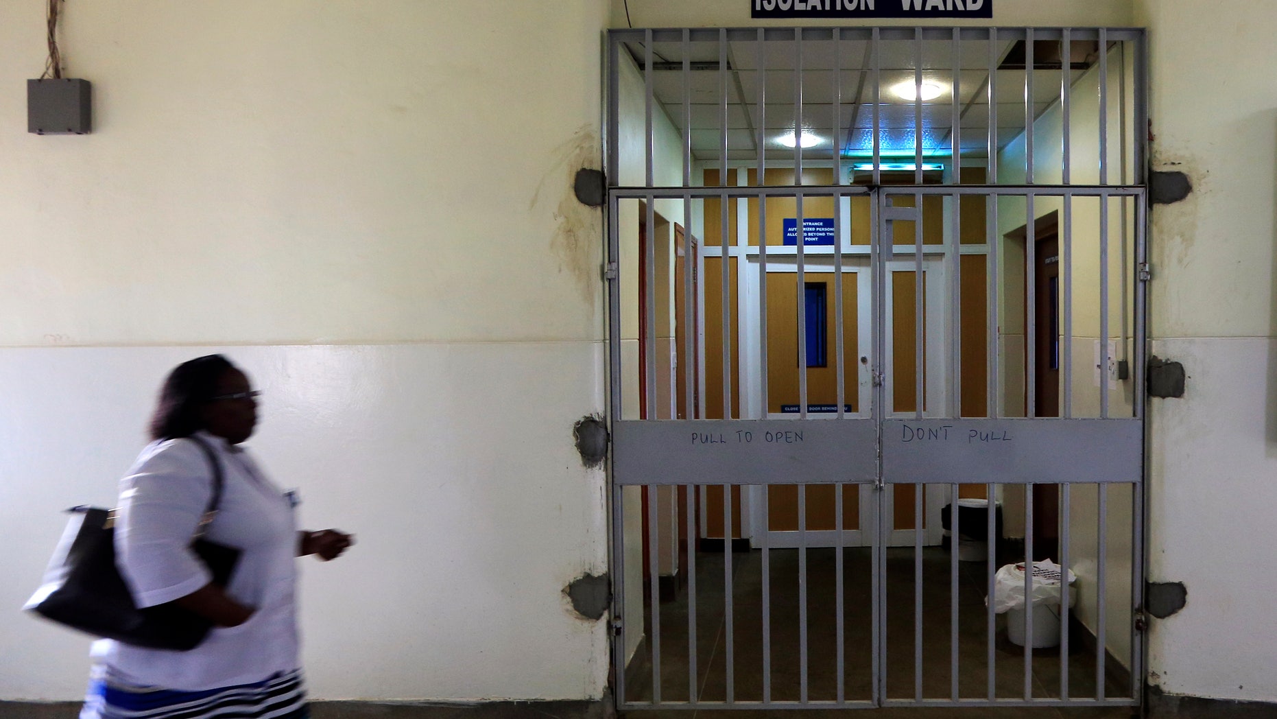 A woman walks past an isolation ward (R) set aside for Ebola related cases at the Kenyatta National Hospital (KNH) in the capital Nairobi August 19, 2014. REUTERS/Noor Khamis