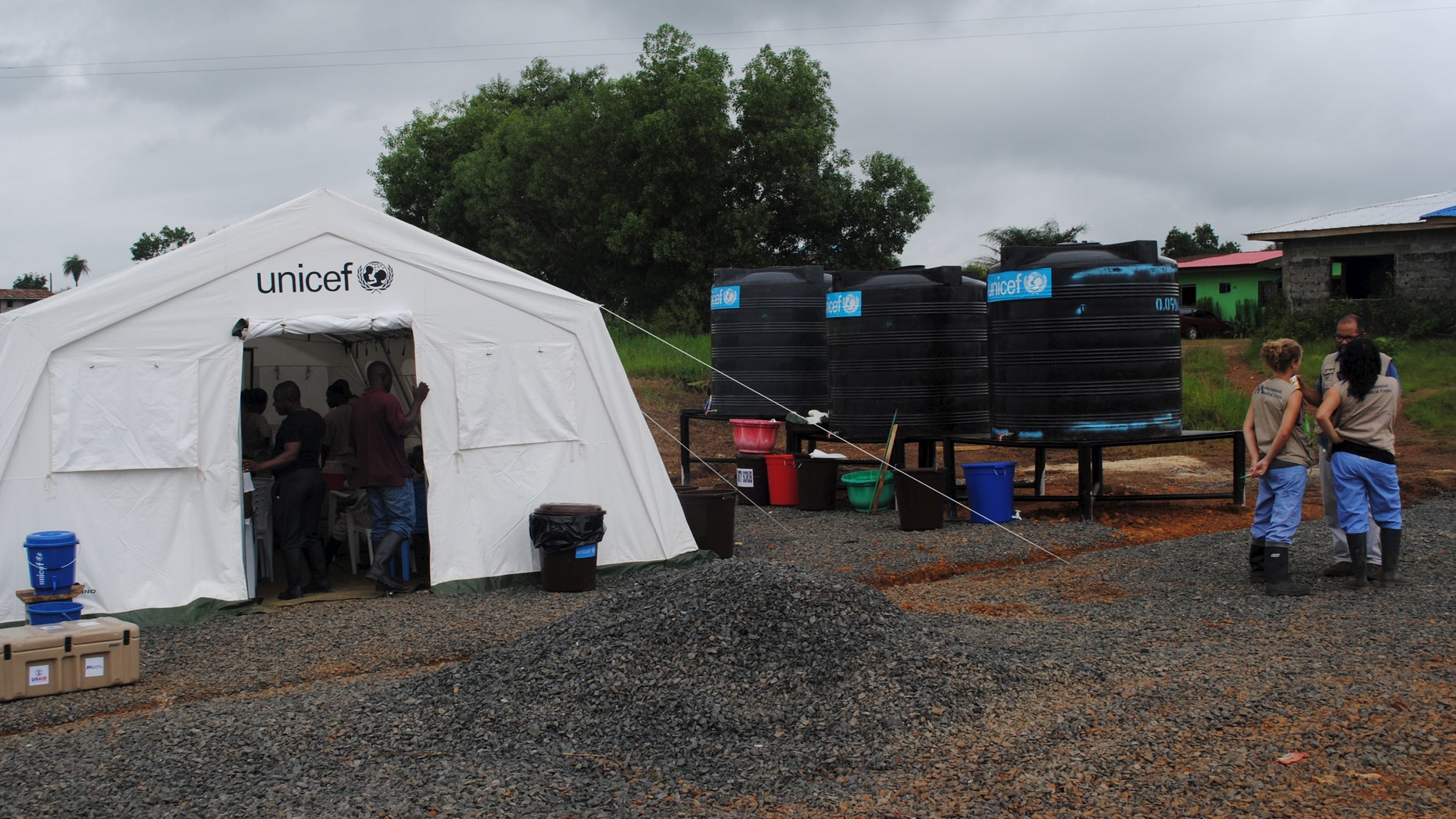 Health workers gather at a clinic in Nedowein, Liberia, July 10, 2015. REUTERS/James Giahyue