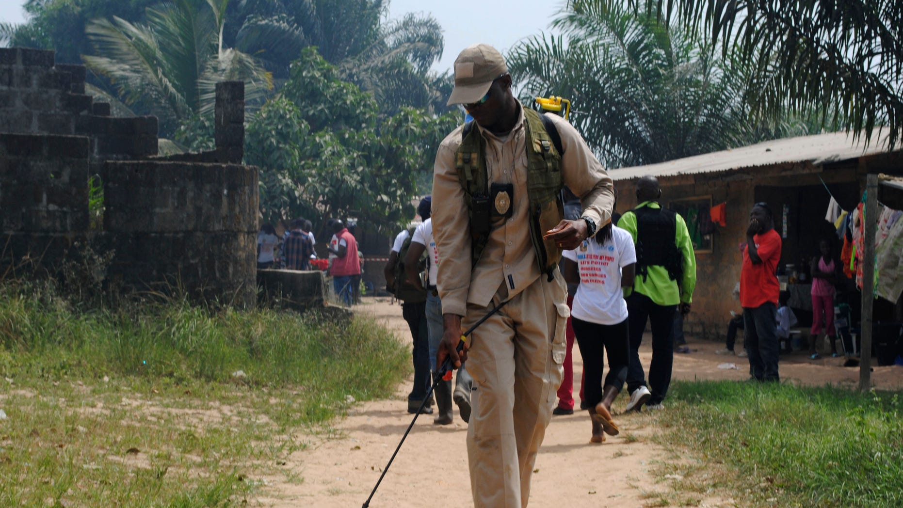 A health worker disinfects a road in the Paynesville neighborhood of Monrovia, Liberia, January 21, 2015. REUTERS/James Giahyue