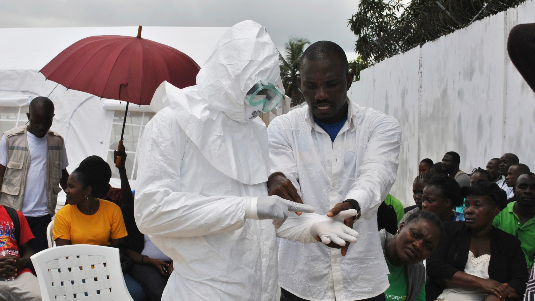 A volunteer health worker practises using a personal protective equipment (PPE) suit at a newly-constructed Ebola virus treatment centre in Monrovia, Liberia, September 21, 2014. REUTERS/James Giahyue