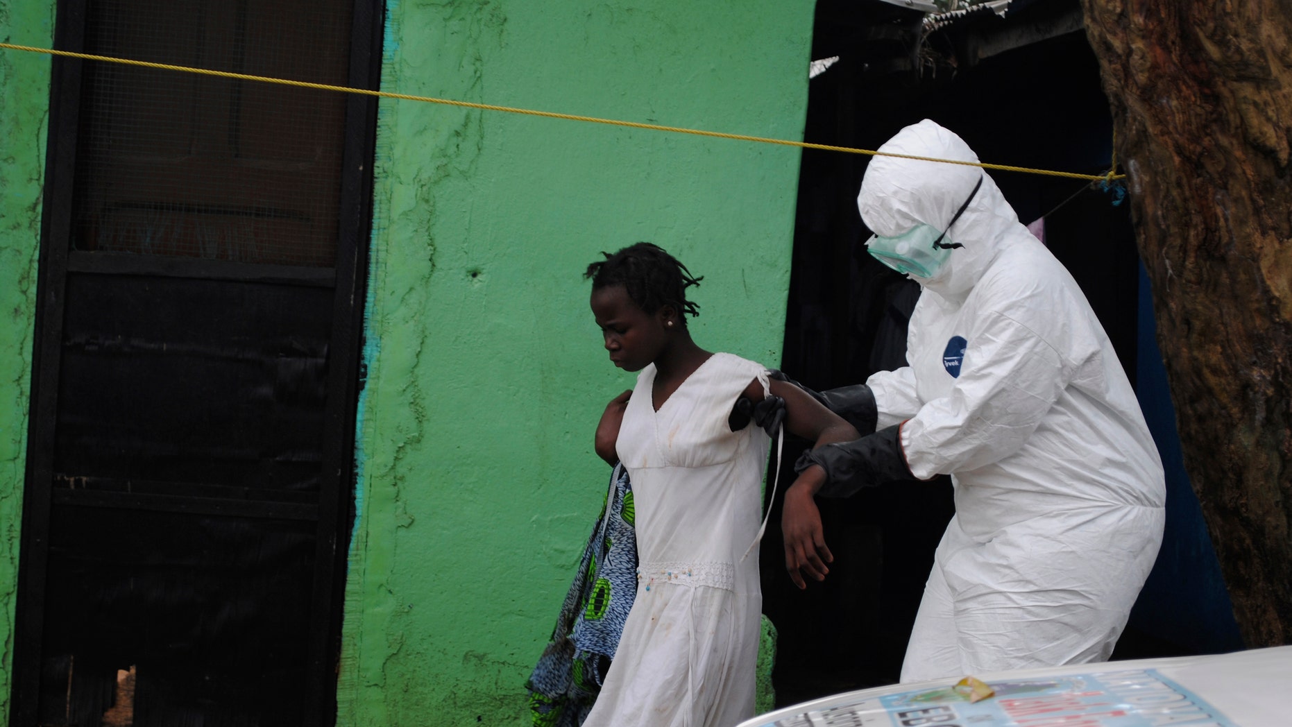 A health worker brings a woman suspected of having contracted the Ebola virus to an ambulance in Monrovia, Liberia, September 15, 2014. REUTERS/James Giahyue