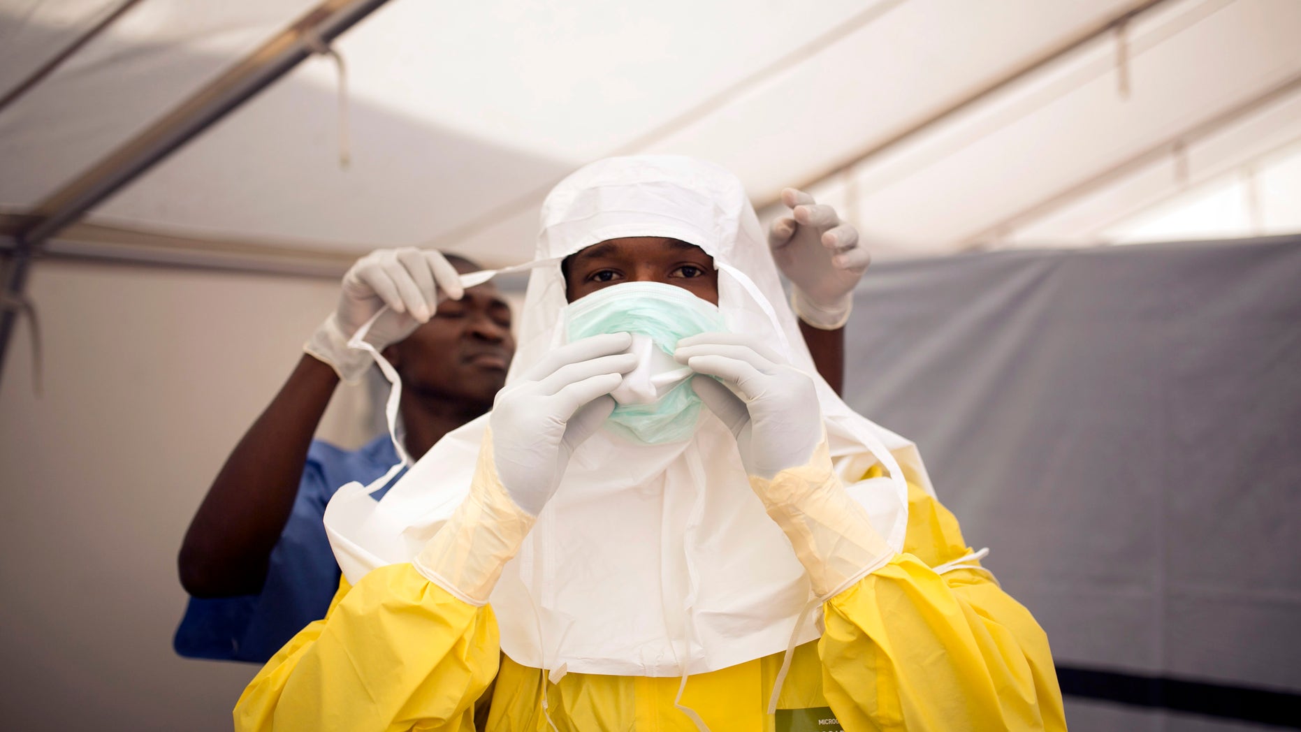 Health workers put on protective gear before entering a quarantine zone at a Red Cross facility in the town of Koidu, Kono district in Eastern Sierra Leone December 19, 2014. REUTERS/Baz Ratner