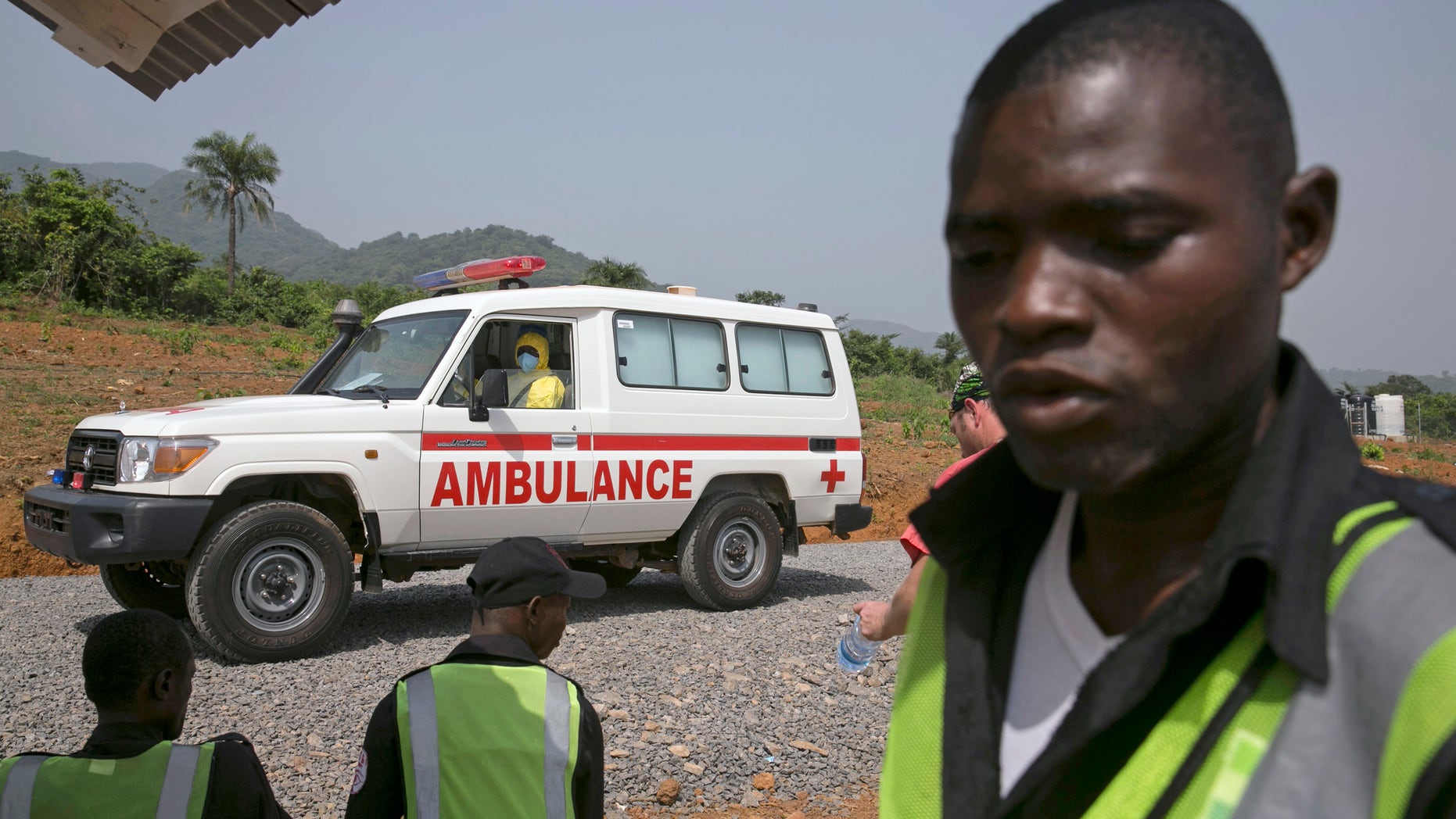 An ambulance transporting a newly admitted Ebola patient drives to the entrance of the Save the Children Kerry Town Ebola treatment centre outside Freetown, Sierra Leone, December 22, 2014.