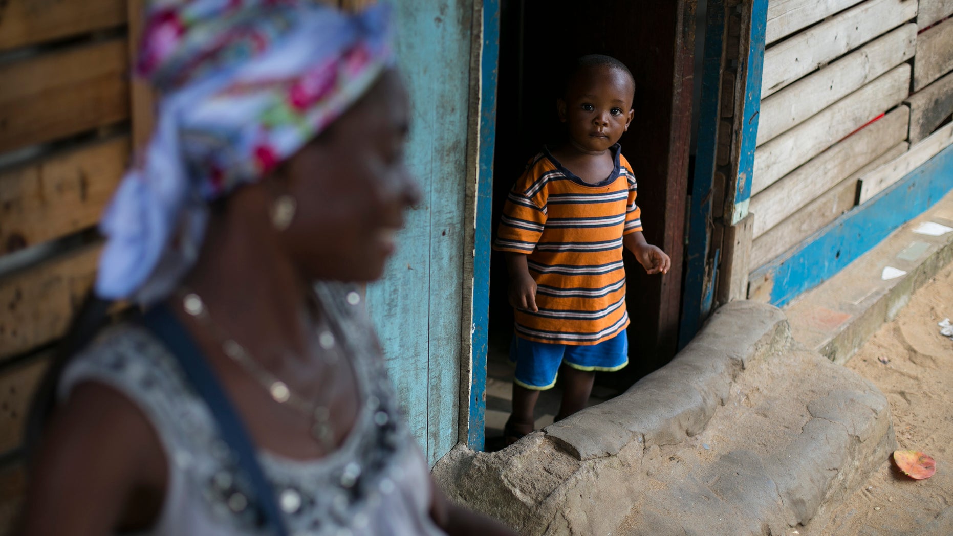 A Sierra Leonean boy looks out of a doorway in Freetown, Sierra Leone, December 16, 2014. REUTERS/Baz Ratner