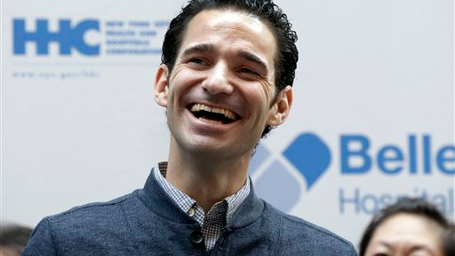 In this Nov. 11, 2014, file photo, Dr. Craig Spencer, who was the first Ebola patient in New York City, listens to comments during a news conference at New York's Bellevue Hospital. (AP Photo/Richard Drew, File)