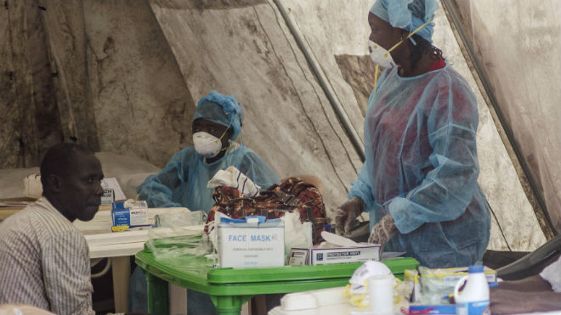 Health workers take blood samples for Ebola virus testing at a screening tent in the local government hospital in Kenema, Sierra Leone, June 30, 2014. REUTERS/Tommy Trenchard