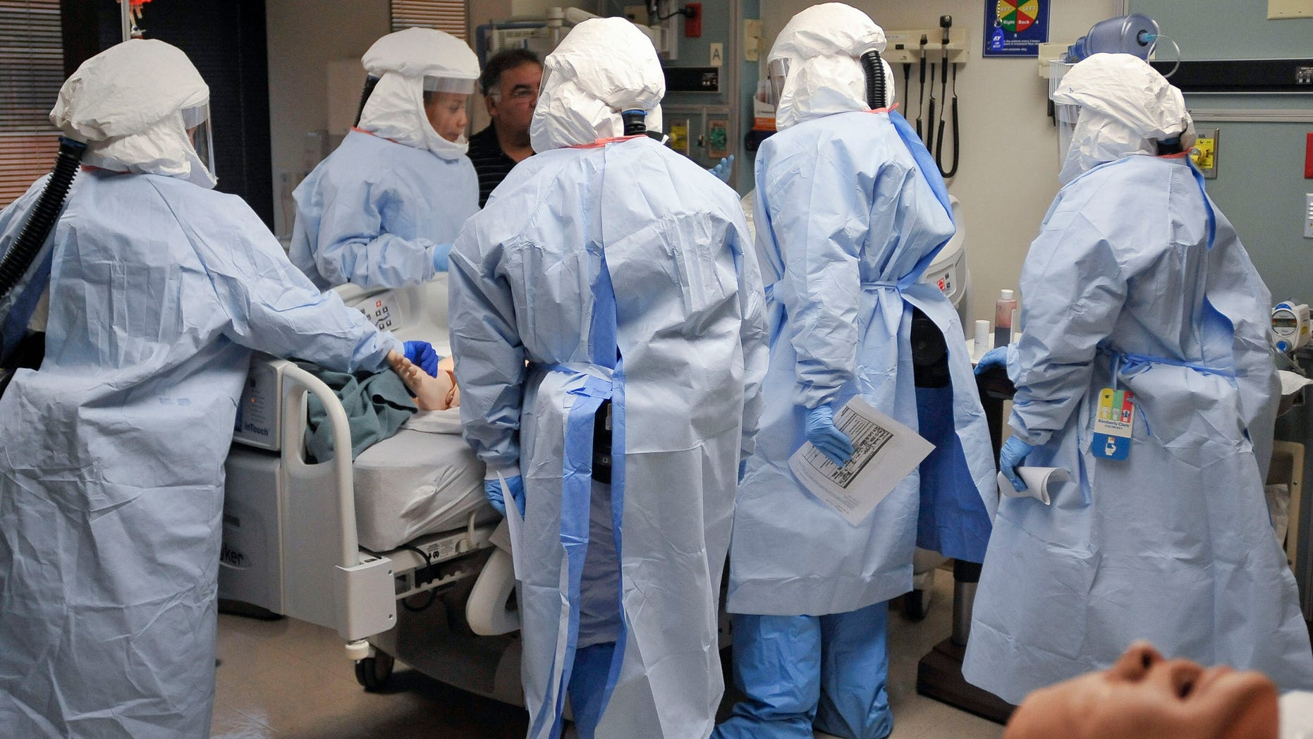 Participants practise a medical procedure on a dummy during training for the Ebola response team at Fort Sam Houston in San Antonio, Texas October 24, 2014. REUTERS/Darren Abate