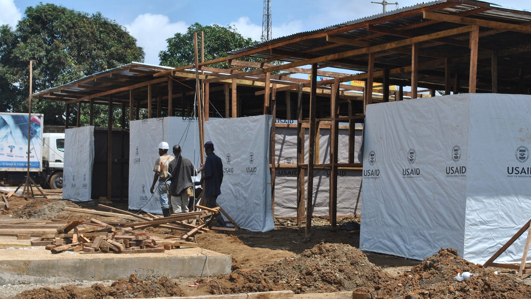 Men work at the construction site of a new Ebola treatment center in Monrovia, Liberia, September 26, 2014. REUTERS/James Giahyue