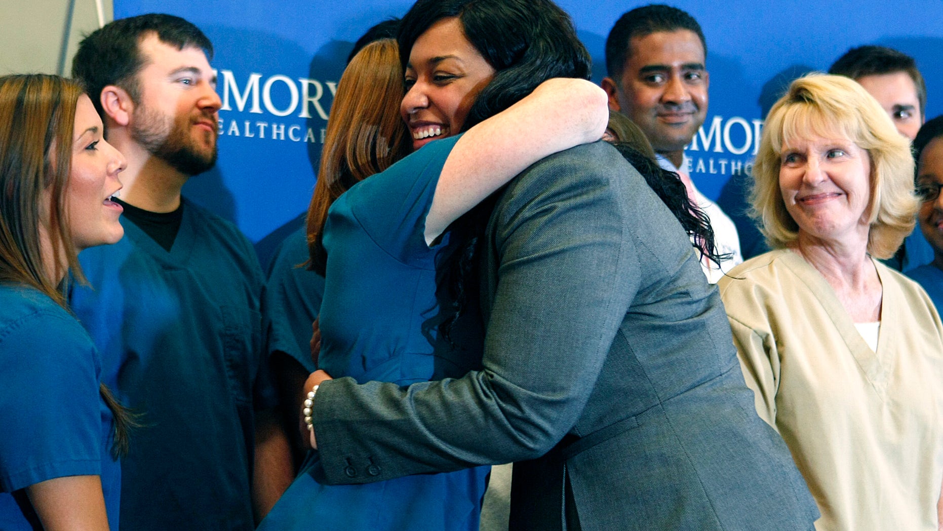 Amber Vinson hugs caregivers before her release from Emory University Hospital in Atlanta, Georgia October 28, 2014. REUTERS/Tami Chappell
