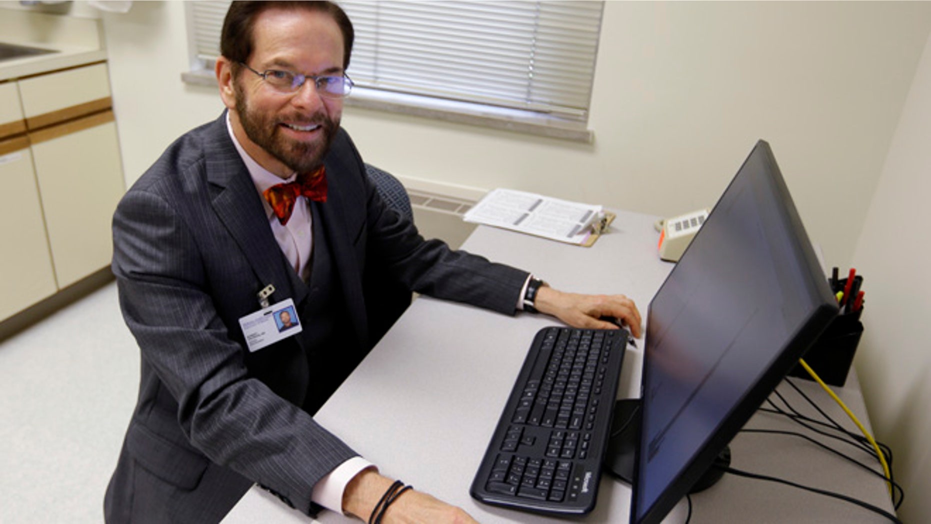 Aug 21, 2014: Dr. Robert Palinkas, director of the McKinley Health Center at the University of Illinois, poses in an exam room in Urbana, Ill. (AP)