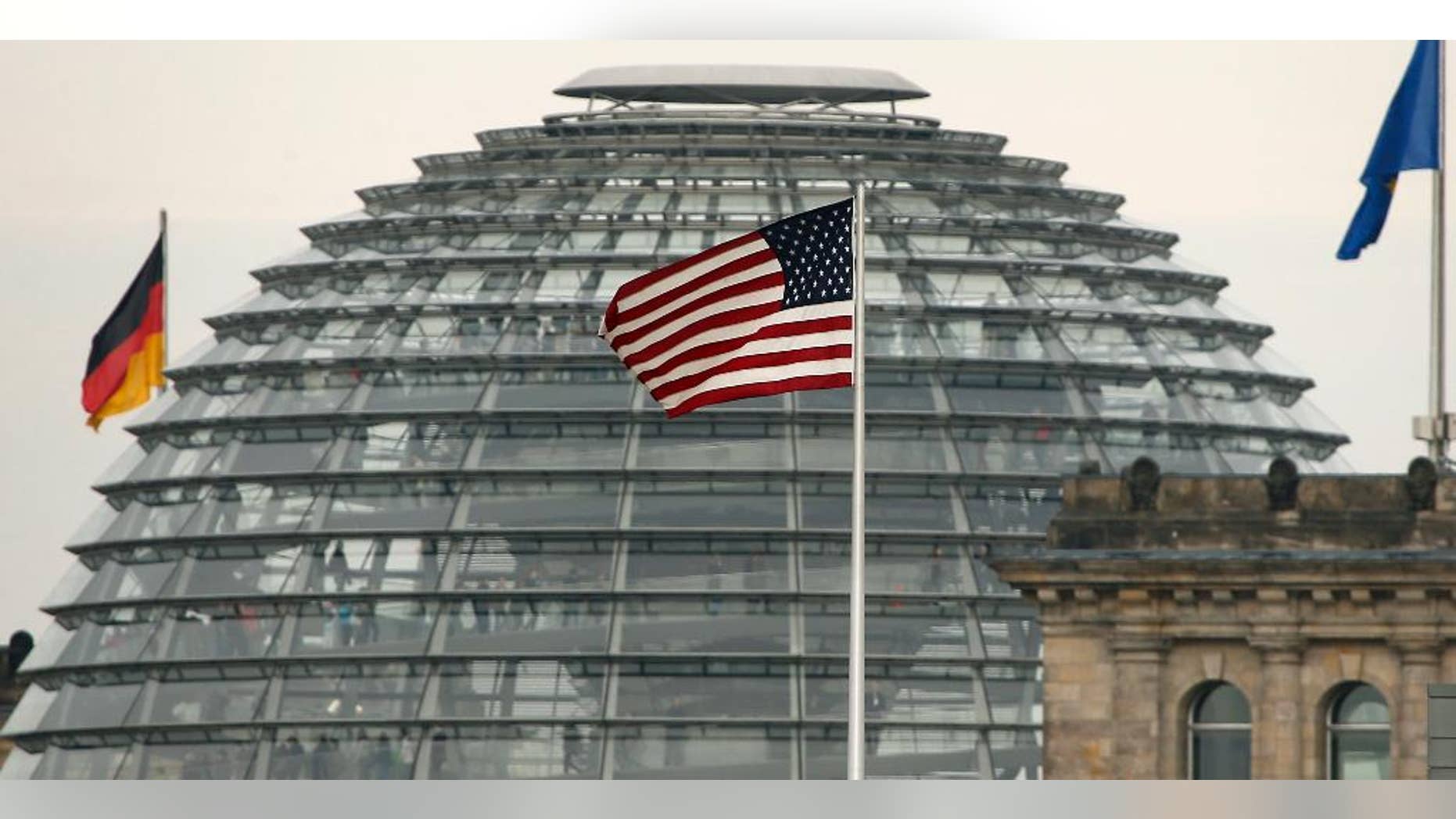 FILE - In this Oct. 25, 2013 file picture the US flag flies on top of the US embassy in front of the Reichstag building that houses the German Parliament, Bundestag, in Berlin, A German official says Chancellor Angela Merkel's chief of staff has asked the U.S. ambassador for a meeting to discuss the latest reports of alleged U.S. spying on Germany. The official says chief of staff Peter Altmaier invited Ambassador John B. Emerson to the chancellery Thursday July 2, 2015. (AP Photo/Michael Sohn,file)