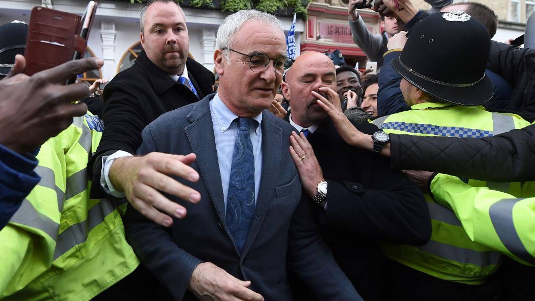 Leicester City manger Claudio Ranieri, leaves San Carlo Pizzeria after a celebratory lunch in Leicester, England Tuesday May 3, 2016. Leicester clinched the most improbable title of the Premier League era when second-place Tottenham was held to a 2-2 draw at Chelsea on Monday night. (Joe Giddens/PA via AP) UNITED KINGDOM OUT