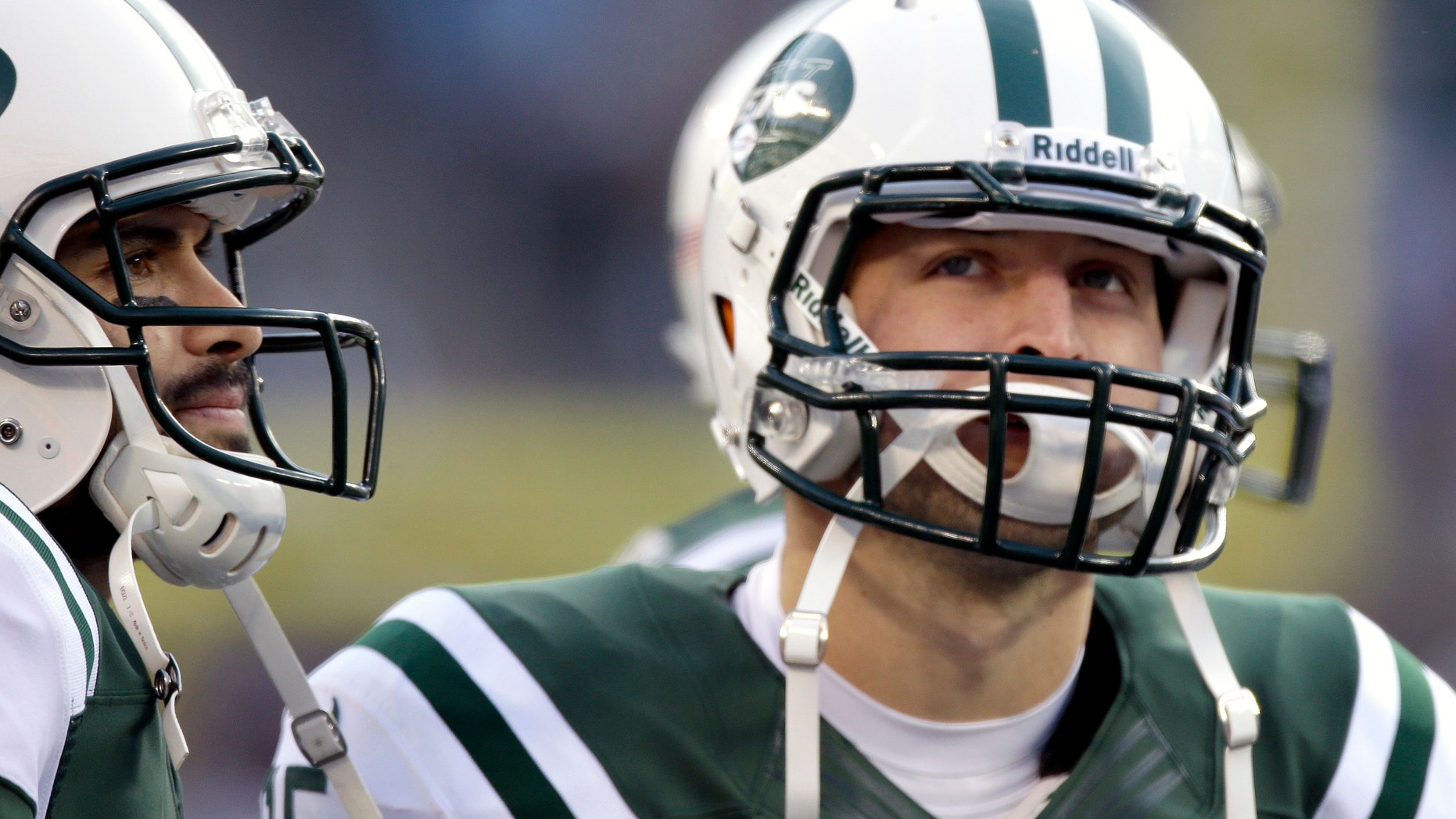 New York Jets quarterbacks Mark Sanchez, left, and Tim Tebow stand next to each other during the second half of an NFL football game against the San Diego Chargers, Sunday, Dec. 23, 2012, in East Rutherford, N.J. (AP Photo/Kathy Willens)