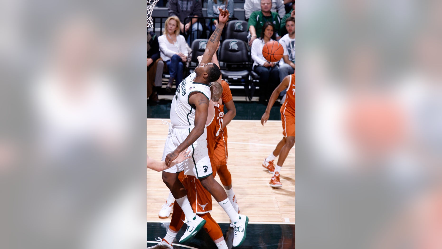 Michigan State's Derrick Nix, left, and Texas' Connor Lammert compete for a rebound during the first half of an NCAA college basketball game, Saturday, Dec. 22, 2012, in East Lansing, Mich. (AP Photo/Al Goldis)
