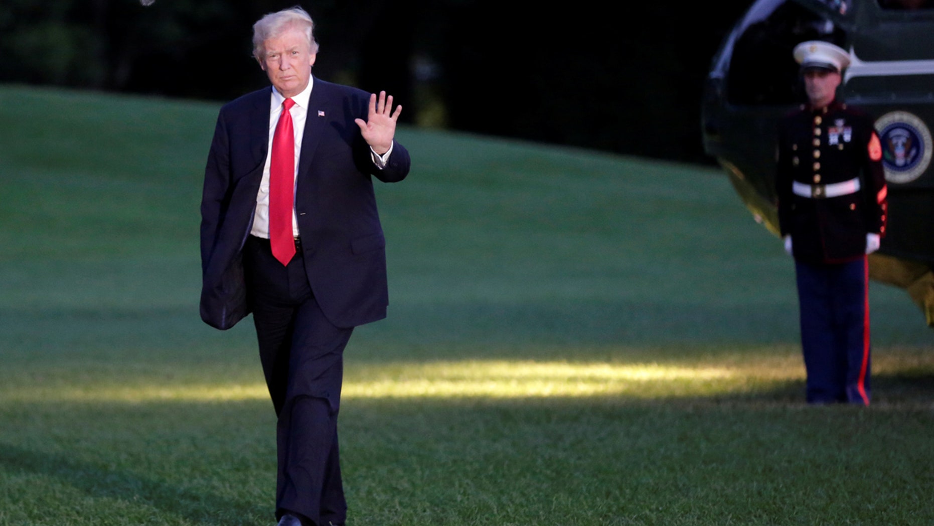 U.S. President Donald Trump waves as walks on the South Lawn of the White House upon his return to Washington, U.S., from the G20 Summit in Hamburg, July 8, 2017.