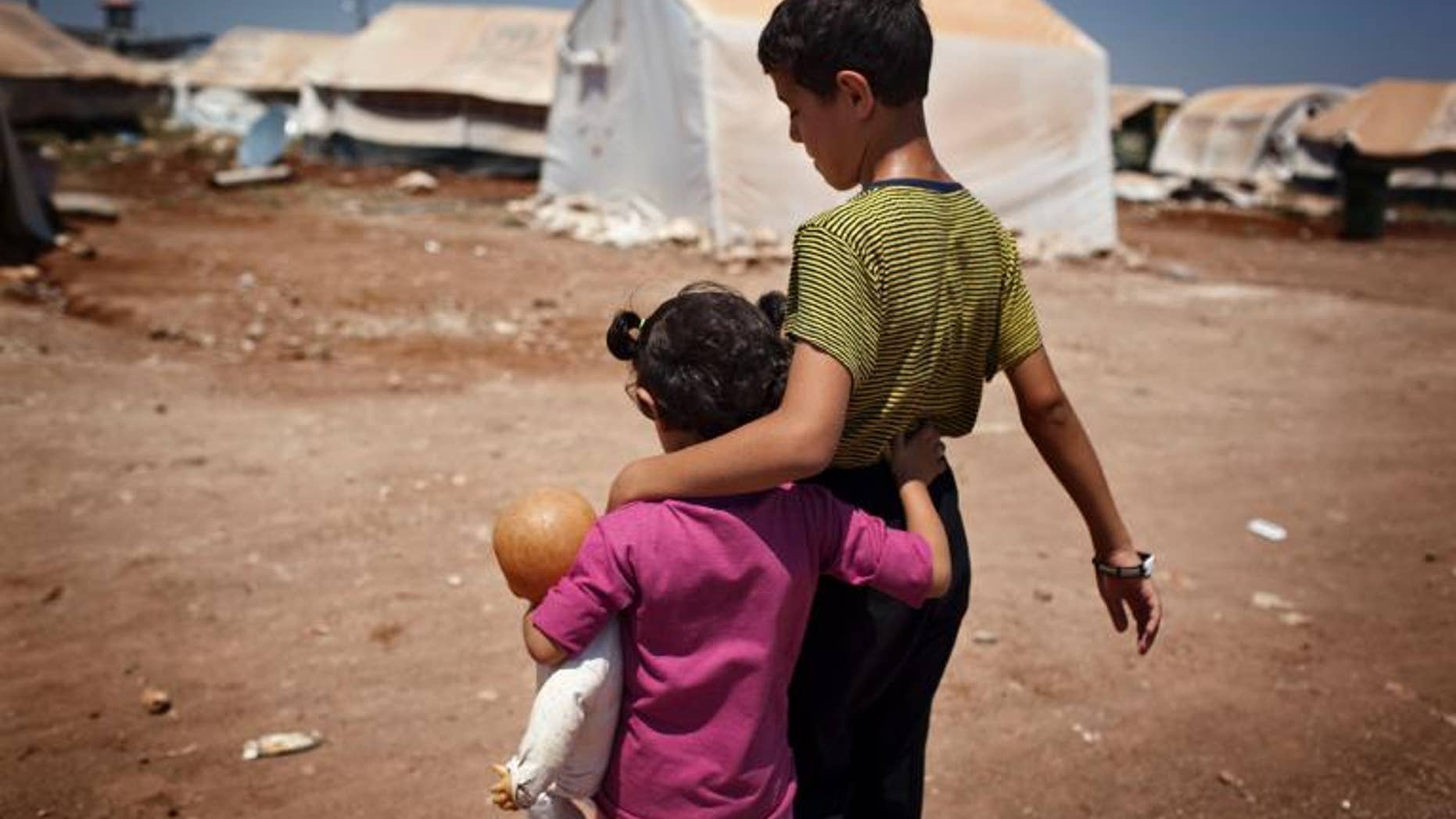 Syrian children walk in the Bab al-Salam refugee camp in Azaz on July 15, 2013
