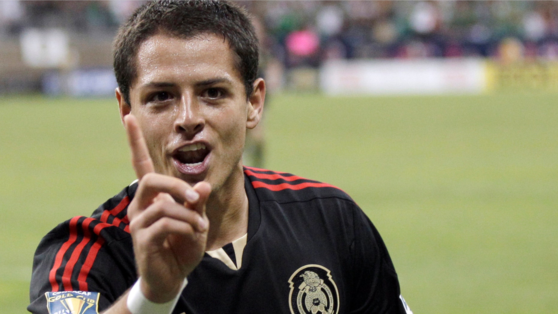 June 22: Mexico's Javier Hernandez gestures after scoring a goal against Honduras during overtime of a CONCACAF Gold Cup semifinal soccer match in Houston. (AP Photo/David J. Phillip)