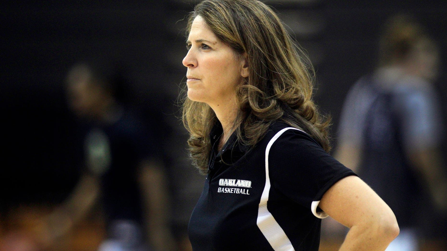 FILE - In this Oct. 16, 2012, file photo, Oakland University women's basketball coach Beckie Francis watches her team' practice in Rochester Hills, Mich. Oakland University says fired women’s basketball coach Francis physically and emotionally abused her players, was obsessed about their weight and pushed her Christian beliefs on them. The Detroit Free Press and The Oakland Press of Pontiac say the suburban Detroit-based public university made the statements in a brief responding to Francis’s suit in Oakland County Circuit Court. (AP Photo/Carlos Osorio, File)