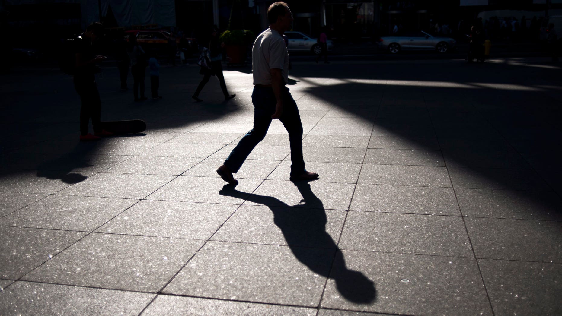 A person walks through Yonge and Dundas Square in Toronto, Friday, Sept, 25, 2015. (Marta Iwanek/The Canadian Press via AP) MANDATORY CREDIT