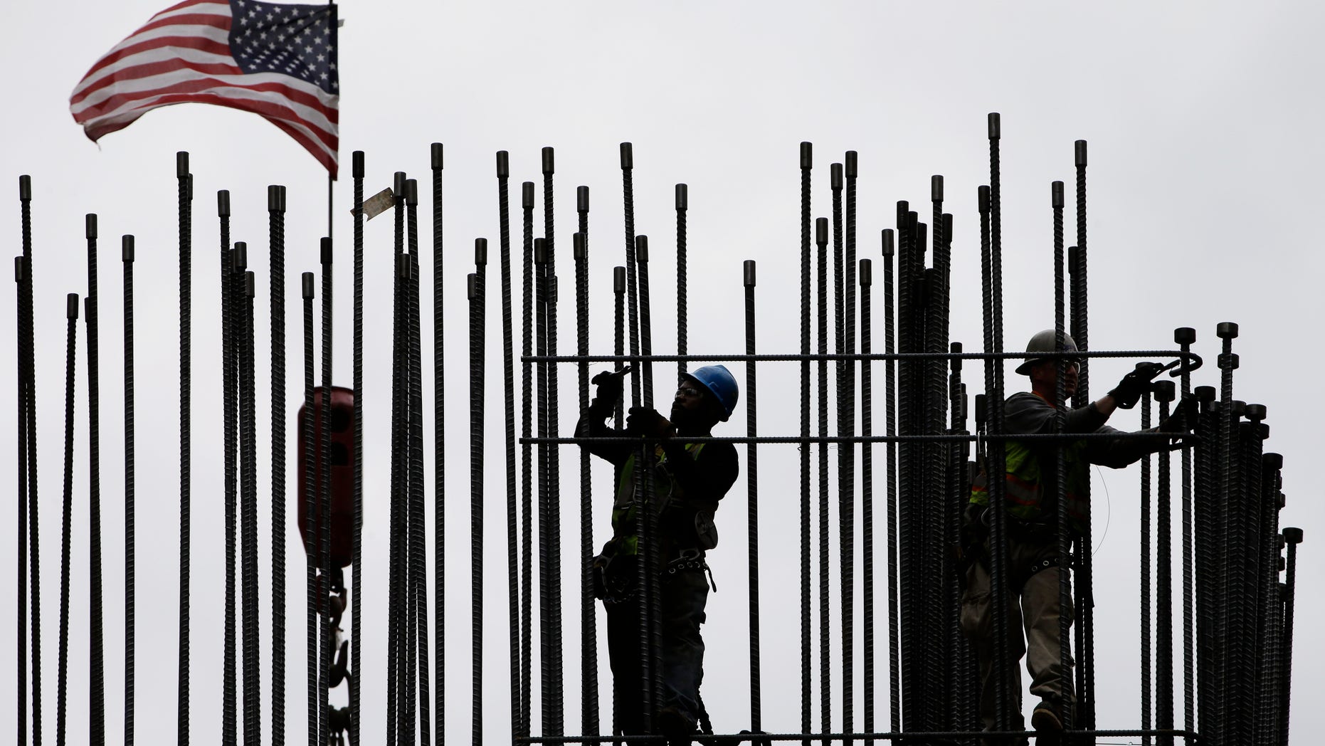 FILE -- April 27, 2015: rodbusters install rebar on the new Comcast Innovation and Technology Center under construction, in Philadelphia. The Commerce Department released first-quarter gross domestic product on May 29, 2015. (AP Photo/Matt Rourke, File)