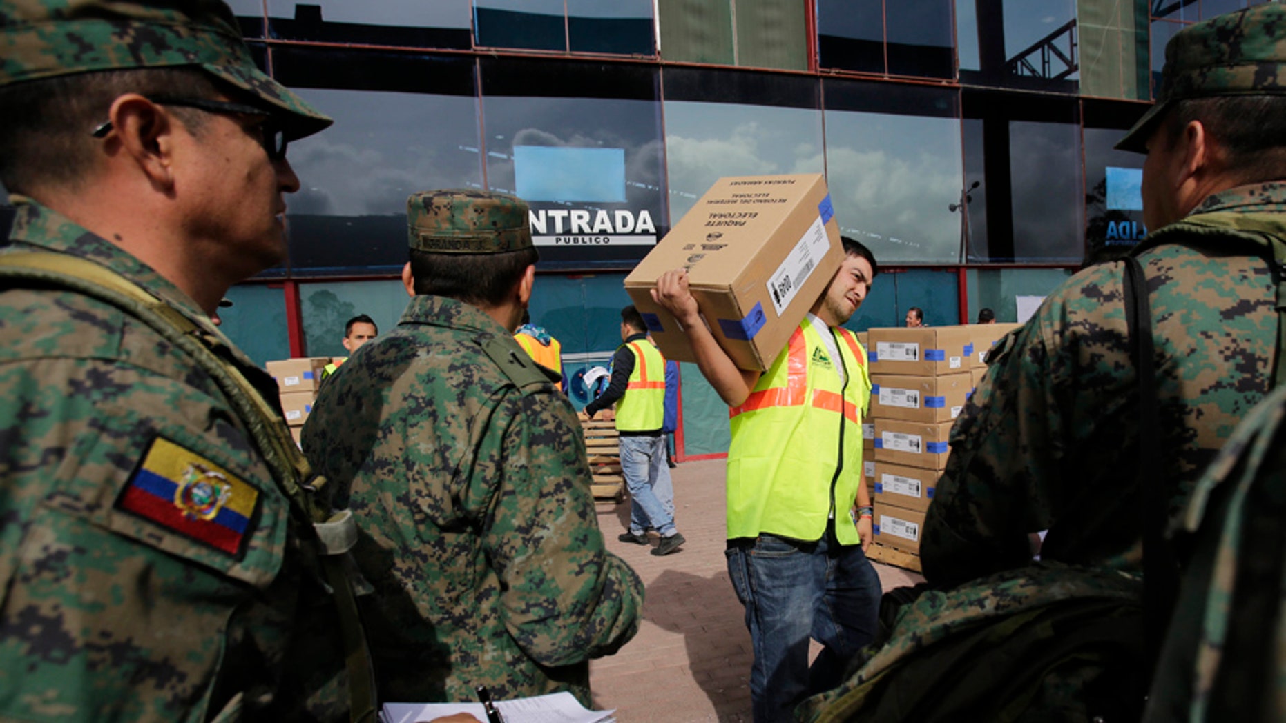 An Ecuador election official carries an electoral kit to be delivered to different polling places by the army, in Quito, Ecuador, Saturday, Feb. 18, 2017. Ecuadoreans will elect a new president, vice-president and National Assembly alongside a referendum on tax havens tomorrow. (AP Photo/Dolores Ochoa)