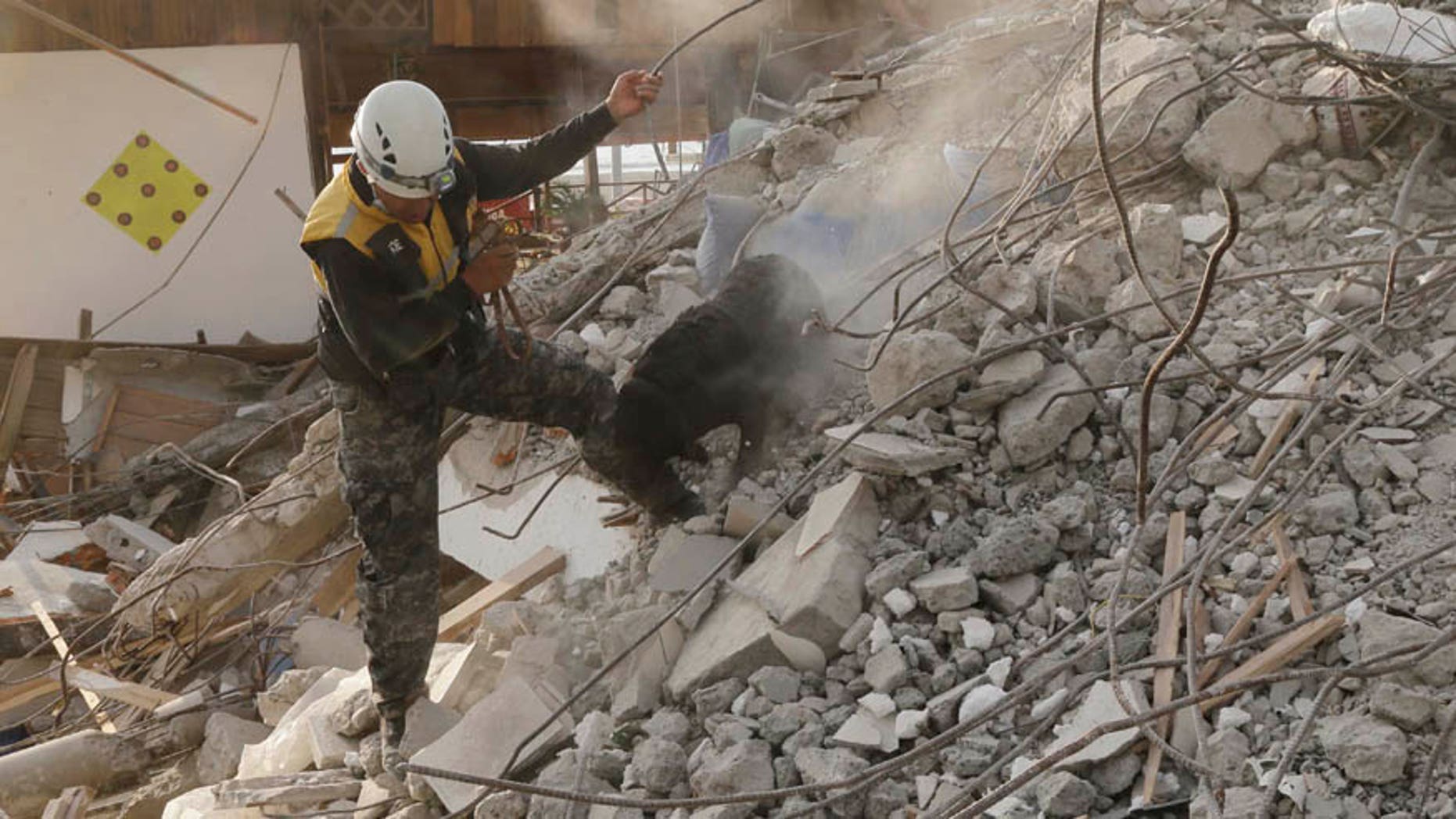 April 19, 2016: A dog rescue unit searches for survivors in the rubble of an earthquake collapsed building in Pedernales, Ecuador.