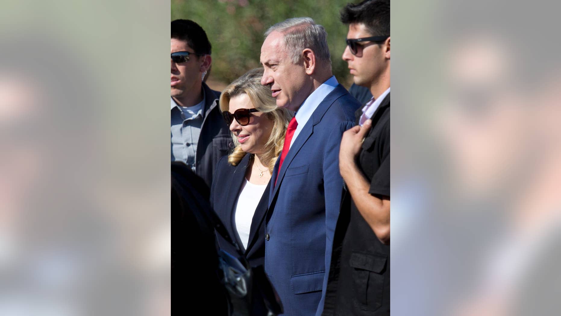 FILE -- In this Nov. 8, 2016 file photo, Israeli Prime Minister Benjamin Netanyahu, center, and his wife Sara attend an inauguration ceremony of the Hahemek rail line in the train station in Afula, Israel. Israeli media are reporting that police questioned the wife of Prime Minister Benjamin Netanyahu as part of the investigation into allegations that he improperly accepted gifts from wealthy supporters. Israel Radio and other media outlets reported Thursday, Jan. 12, 2017, that Sara Netanyahu was interviewed by police the night before. Police had no immediate comment. (AP Photo/Ariel Schalit, File)