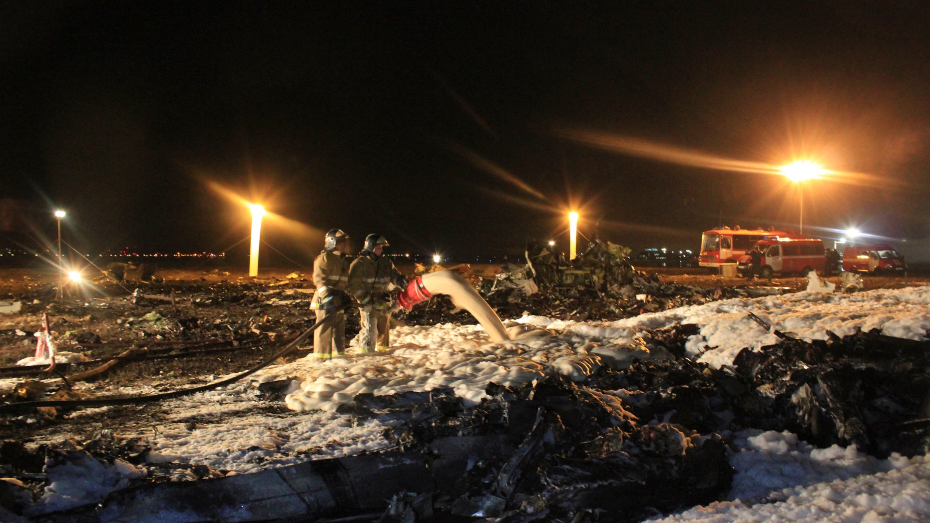 In this photo taken on Sunday, Nov. 17, 2013 and provided by Russian Emergency Situations Ministry fire fighters and rescuers work at the crash site of a Russian passenger airliner near Kazan, the capital of the Tatarstan republic, about 720 kilometers (450 miles) east of Moscow. A Russian passenger airliner crashed Sunday night while trying to land at the airport in the city of Kazan, killing all people aboard, officials said. The Boeing 737 belonging to Tatarstan Airlines crashed an hour after taking off from Moscow. There were no immediate indications of the cause. (AP Photo/Russian Emergency Situations Ministry)