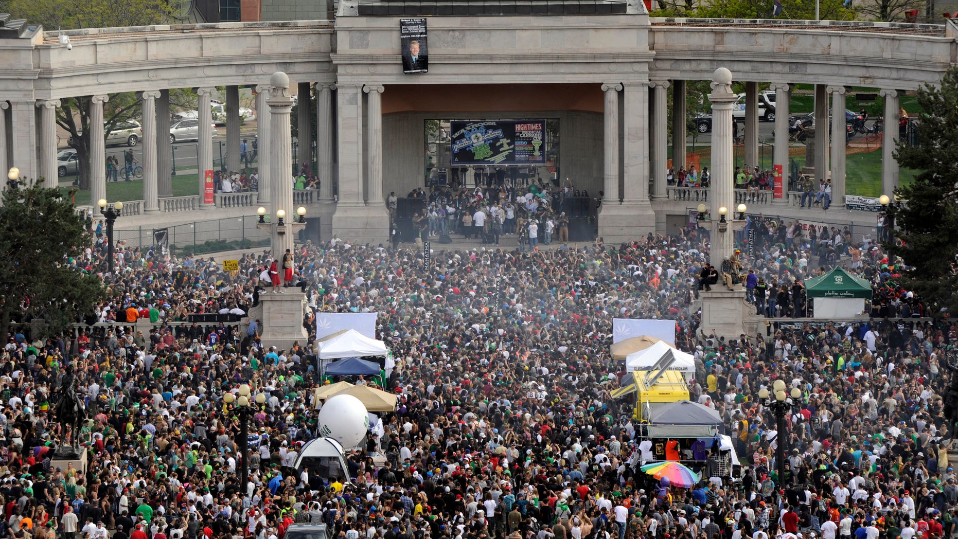 FILE - This April 20, 2012 file photo shows a cloud of smoke covering the crowd at the Denver 420 rally in Civic Center Park. Denver Police are bracing for this year's event on Saturday, April 20, 2013 which is expected to draw a record crowd of 80,000 people. (AP Photo/The Denver Post, Daniel Petty, File)