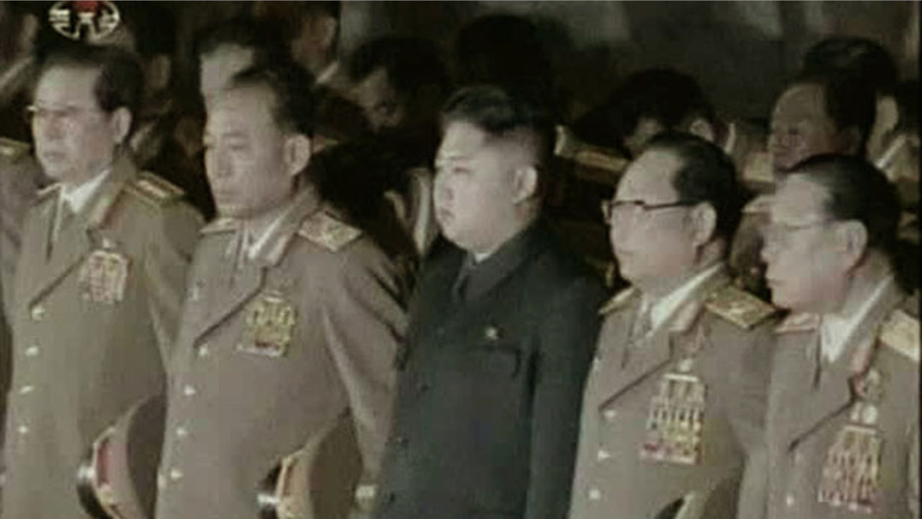Dec. 24, 2011: Kim Jong Un, center, North Korean leader Kim Jong Il's youngest known son and successor, with military officials, stand in front of his father's body displayed in a glass coffin, not in photo, at Kumsusan Memorial Palace in Pyongyang, North Korea.