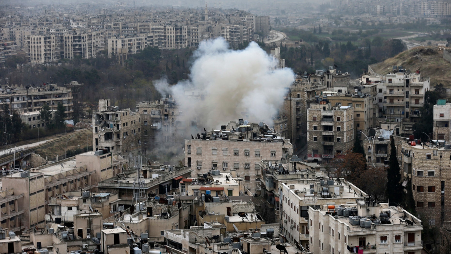Smoke rises after rebel fighters launch a mortar shell on residential neighborhood in west Aleppo, Syria, Monday, Dec. 5, 2016.