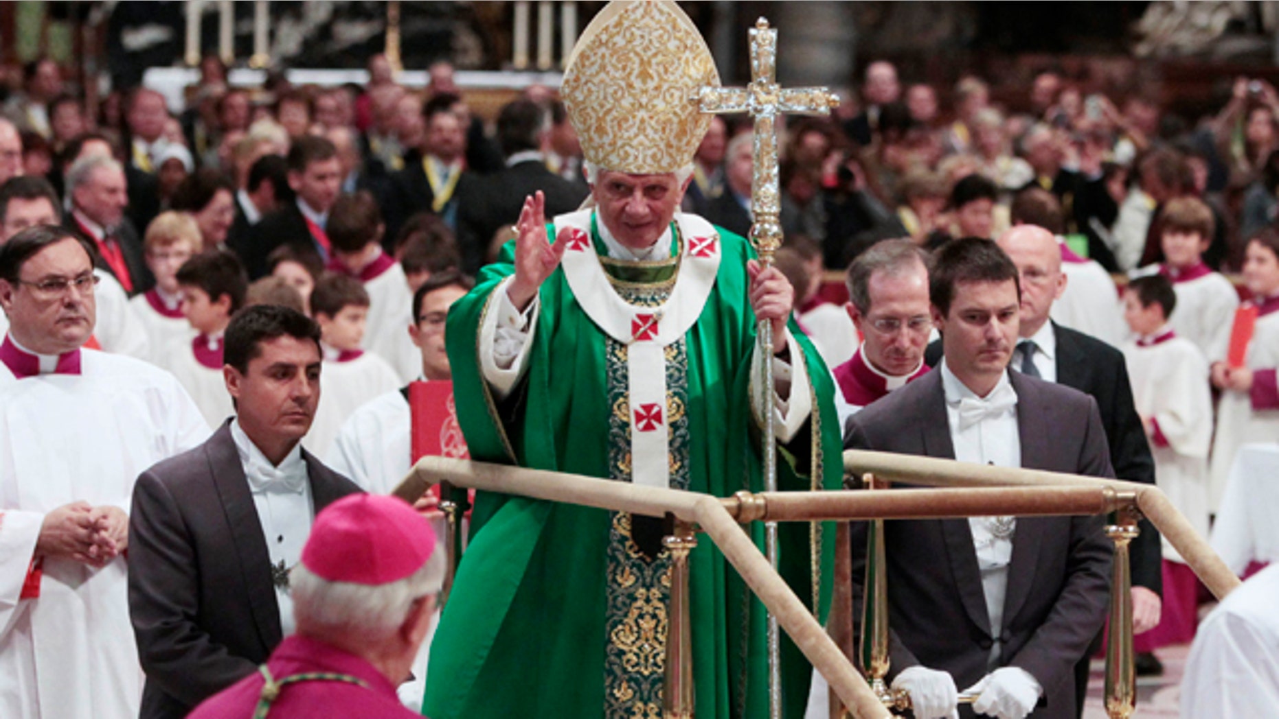 Oct. 16: Pope Benedict XVI stands on a mobile platform as he leaves St. Peter's Basilica at the end of a mass at the Vatican.