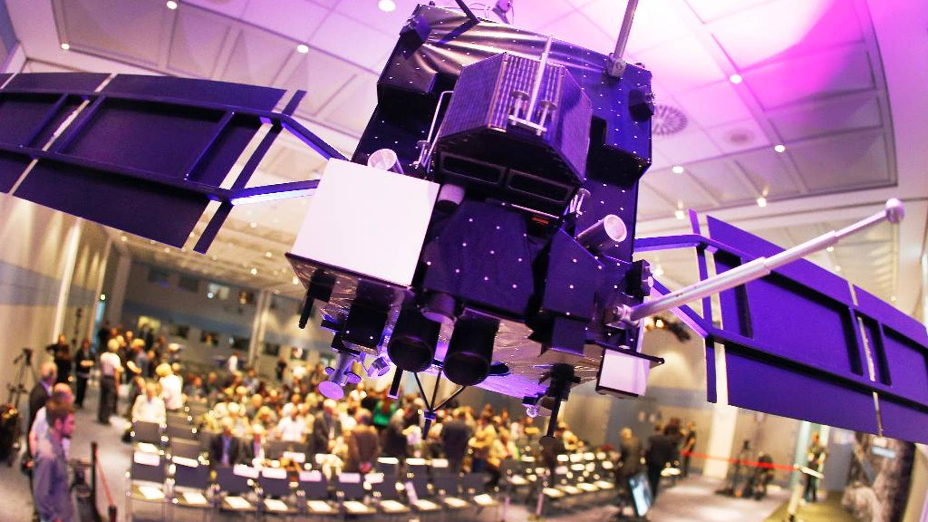 A model of orbiter Rosetta hangs from the ceiling in a conference room at the European Space Agency ESA in Darmstadt, Germany, Friday, Sept. 30, 2016. Rosetta will be impacted on comet 67P/Churyumov-Gerasimenko on Friday, marking the end of the twelve years lasting Rosetta mission. (AP Photo/Michael Probst)