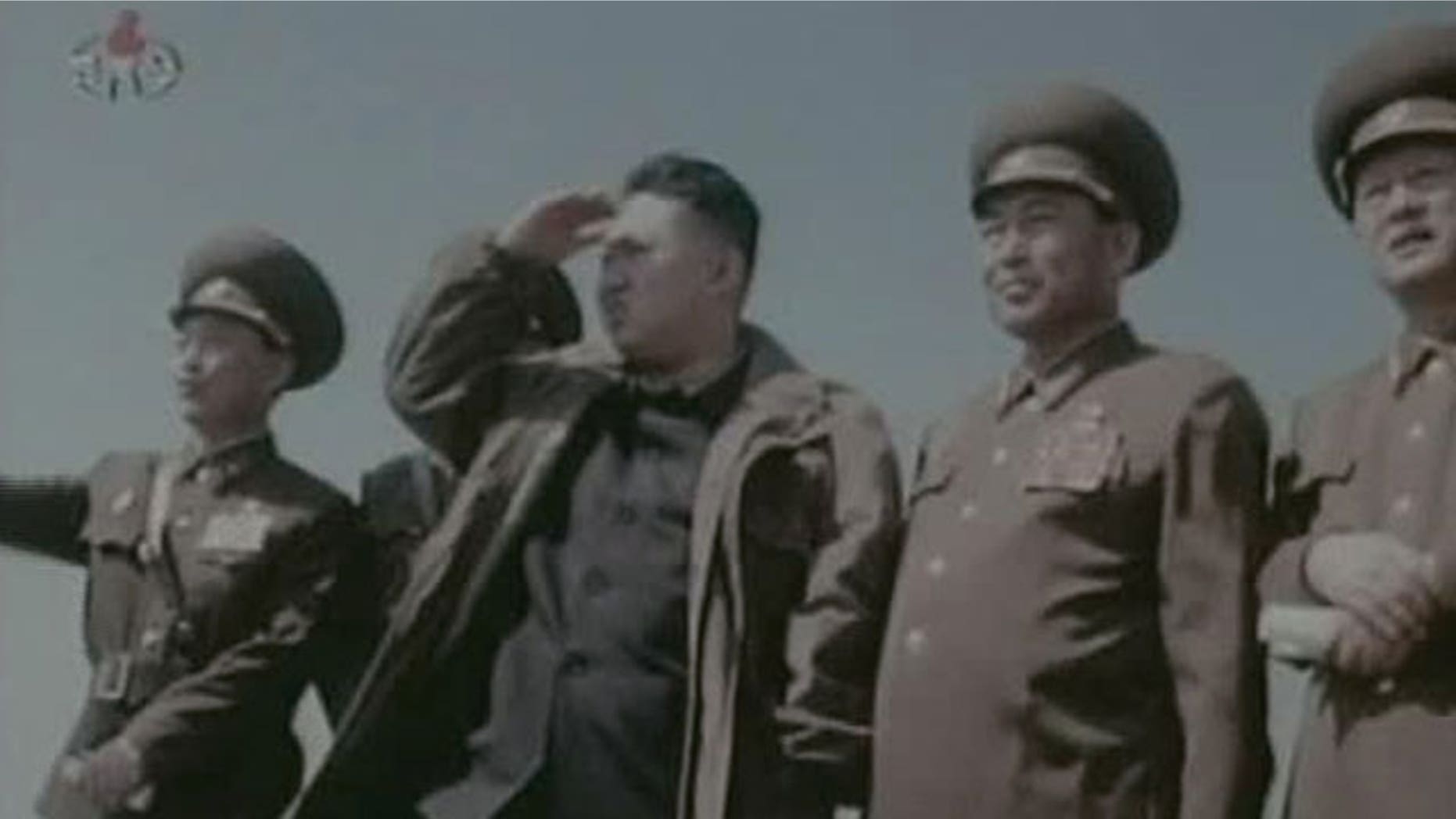In this undated image made from KRT video, North Korea's new young leader Kim Jong Un, third from right, watches jet fighters with North Korean officials at an undisclosed place in North Korea.