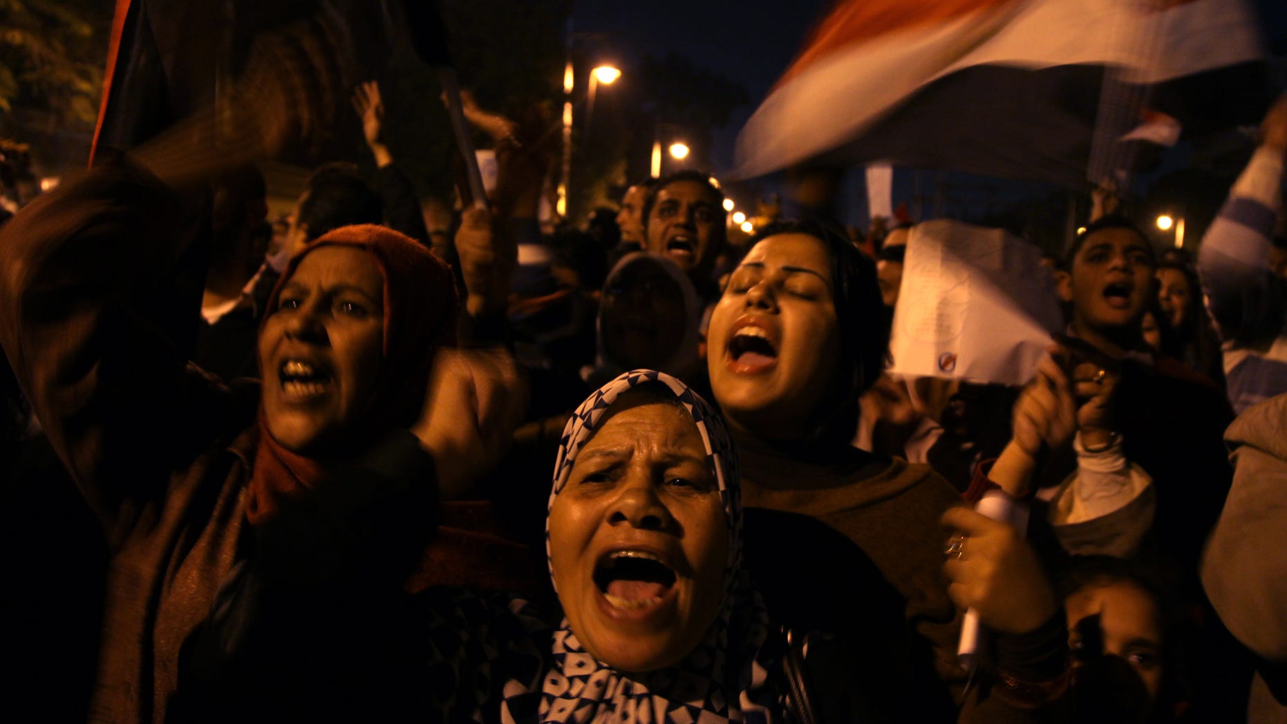 Dec, 18, 2012: Egyptian protesters opposing president Mohammed Morsi chant slogans during a protest against President Mohammed Morsi, in front of the presidential palace in Cairo, Egypt.