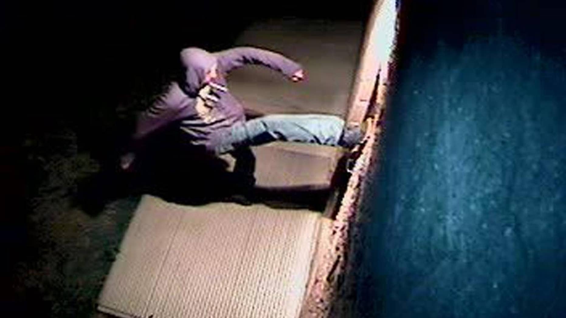 In this Sunday, March 26, 2017, still image from a video surveillance camera, a suspect is shown during the vandalizing of a mosque near Colorado State University in Fort Collins, Colo. Police are asking for the public's help in identifying the person who overturned benches, broke windows and threw a Bible into a mosque near Colorado State University, a case they are investigating as a hate crime. (Fort Collins Police Department via AP)